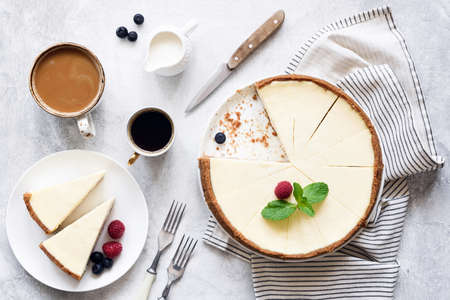 Classic New York Cheesecake And Coffee on White Concrete Background, Top View. Coffee and Cheesecakeの写真素材
