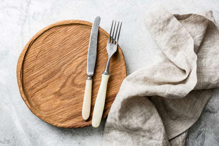 Rustic table setting with vintage silverware, wooden board and textile. Top view, copy space for textの写真素材