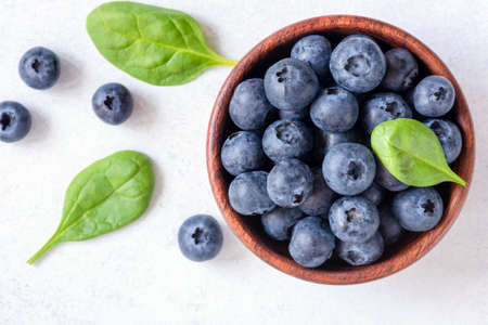 Fresh blueberries in bowl on white background, top view. Juicy ripe blueberries. Blueberries isolated on white. Top view selective focusの写真素材