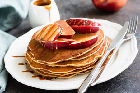 Pancakes with Caramel Apples. Homemade American Pancakes with Camarlized Apples on White Plate