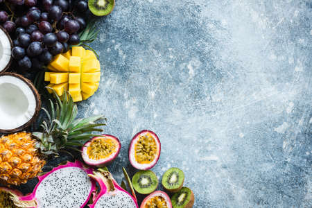 Fresh tropical fruits exotic fruits on concrete background with copy space. Food background. Vegan, summer, healthy eating and healthy lifestyle conceptの写真素材