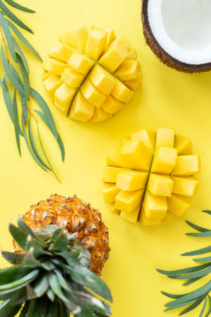 Tropical fruit pattern on yellow background. Fruits flat lay, healthy lifestyle and summer concept. Table top viewの写真素材