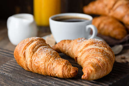 Croissants, coffee and orange juice. Continental breakfast. Closeup viewの写真素材