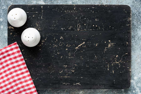 Blackboard or black cutting board and kitchen textile with copy space for text. Restaurant, cafe...