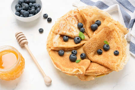 Tasty crepes with blueberries. French crepes, russian or ukrainian blini or blintzes with fresh...