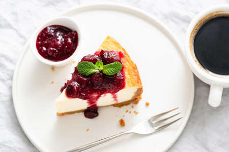 Slice Of Cheesecake With Cherry Sauce And Cup Of Coffee. Top View. Flat Lay. Breakfast Or Coffee Break at cafe or restaurantの写真素材