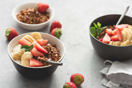 Fruits with granola and yogurt in bowl for breakfast. Morning light. Concept of healthy eating, healthy lifestyleの写真素材