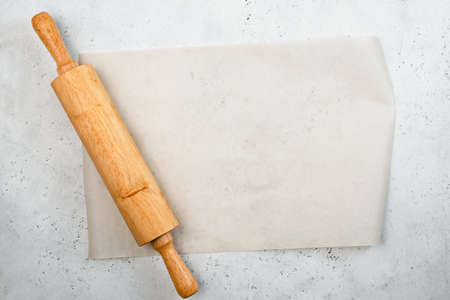Rolling pin and baking paper background with copy space for text, recipe, menu. Baking or cooking food backgroundの写真素材