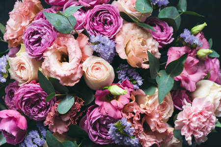 Beautiful pink and purple Peonies and roses bouquet with eucalyptus. Closeup view. Wedding or Birthday bouquet of flowersの写真素材