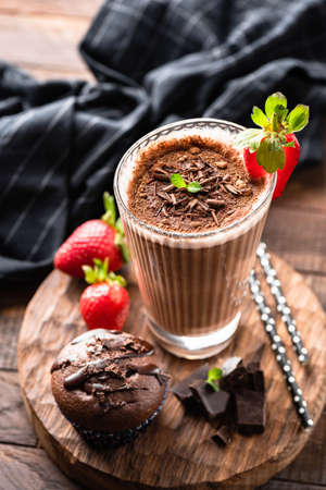 Tasty Chocolate Cocktail, Ice Mocha Coffee Cappucino or Milkshake In Tall Glass Cup Served With Chocolate Muffin. Selective focusの写真素材