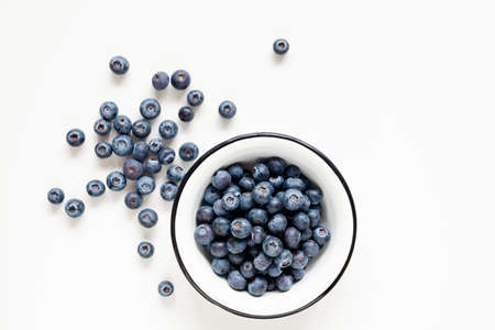 Blueberries in bowl isolated on white background, table top viewの写真素材