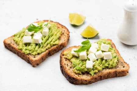 Bread toast with mashed avocado and feta cheese. Healthy breakfast or snackの写真素材