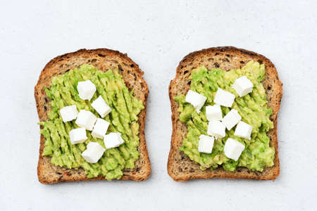 Toast with avocado and feta cheese isolated table top viewの写真素材
