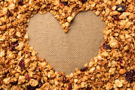 Frame of tasty homemade granola with heart shape copy space.の写真素材