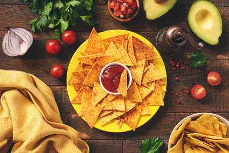 Corn tortilla chips Nachos with tomato sauce on plate.の写真素材