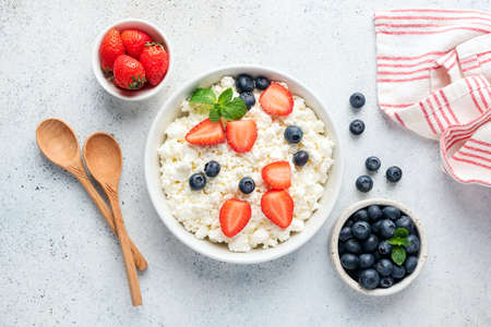 Cottage cheese, curd cheese or tvorog with fresh berries. Top view flat lay composition