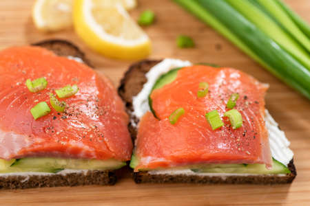 Smoked salmon sandwiches with rye bread, cream cheese and cucumber.