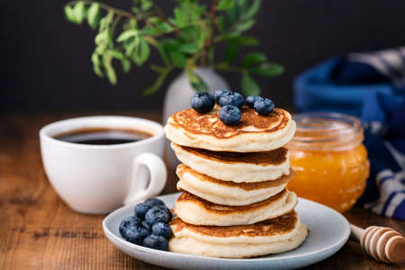 Pancakes with blueberries and honey. Stack of tasty buttermilk pancakes. Horizontal composition,...
