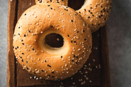 Sesame bagels on wooden board closeup viewの写真素材