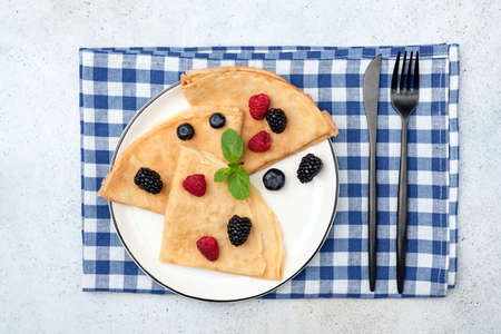 French Crepes With Berries Folded On White Plate.の写真素材