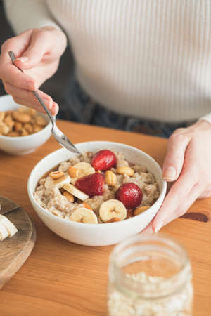 Oatmeal porridge with fruits and berries for healthy breakfast.