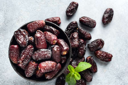 Dry medjool dates in bowl, top view.の写真素材