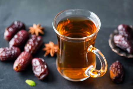 Turkish tea and dried dates on black