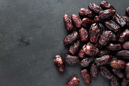 Dried red dates on black slateの写真素材