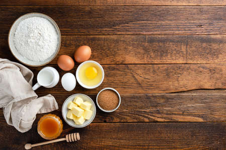 Baking ingredients and tools on rustic wooden background. Baking a cake, cookies or pastry. TOp view copy spaceの写真素材