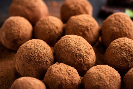 Chocolate truffles with cocoa powder, closeup view. Round chocolate candyの写真素材