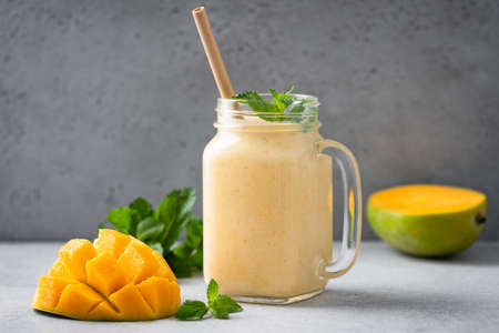 Jar of mango lassi or mango yogurt smoothie. Healthy tropical fruit smoothieの写真素材