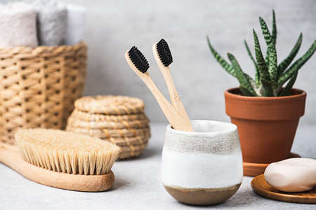 Charcoal toothbrush in bathroom with anticellulite brush, antibacterial soap. Sustainable lifestyleの写真素材