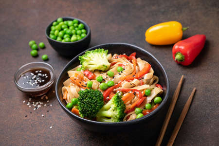 Asian vegetarian udon noodles with vegetables in a bowlの写真素材