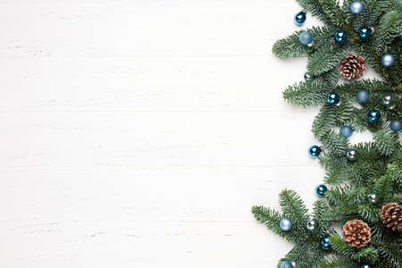 Christmas, New Year white wooden background with fir tree branches. Copy space for text, design