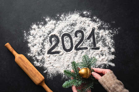 2021 written with flour on black background, top view. New Year, Christmas greeting conceptの写真素材