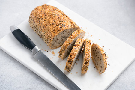 Sliced whole grain bread. Bread with seeds, multigrain bread on marble board