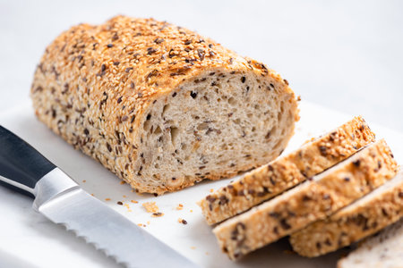 Multigrain wheat bread sliced on marble board. Closeup view. Texture of whole grain breadの写真素材