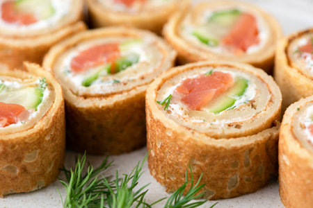 Salmon, cucumber and cream cheese crepe rolls. Appetizer finger food closeup viewの写真素材