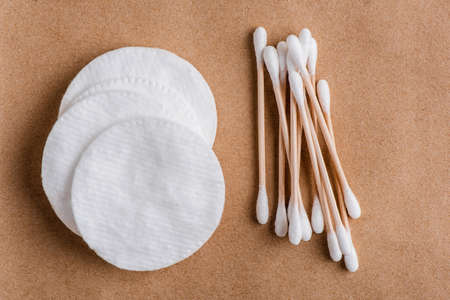Eco cotton pads and bamboo ear sticks on craft paper backgroundの写真素材