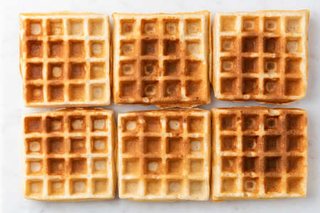 Belgian waffles texture isolated on white background. Six plain sweet home baked belgian waffles...