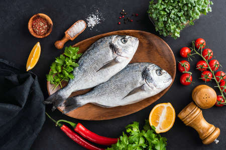 Dorado fish with vegetables and spices ready for cookingの写真素材