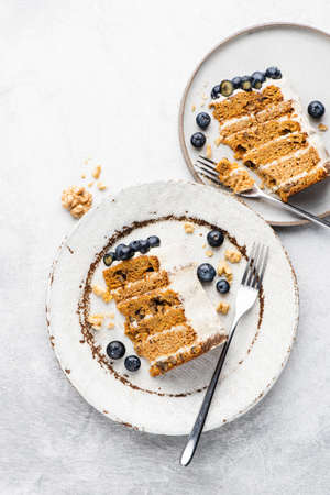 Carrot cake with cream cheese frosting and blueberries