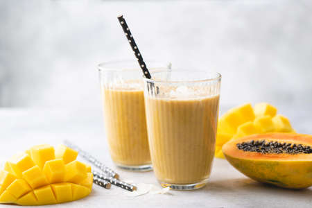 Yellow mango papaya smoothieの写真素材