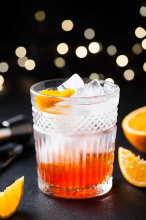 Orange Alcohol cocktail with ice in whiskey glass