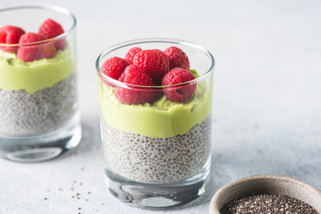 Healthy chia pudding with avocado mousse and raspberriesの写真素材