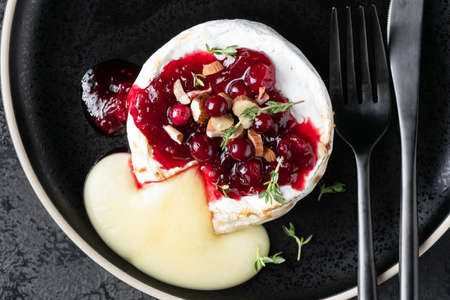 Baked camembert cheese with cranberries and nutsの写真素材