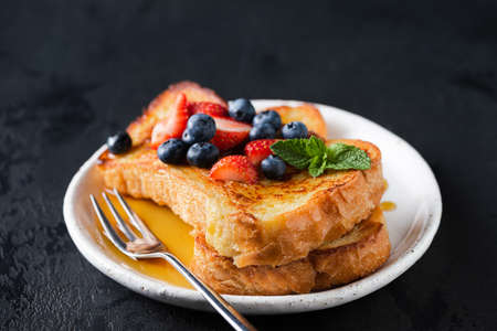 French toast with berries and honeyの写真素材