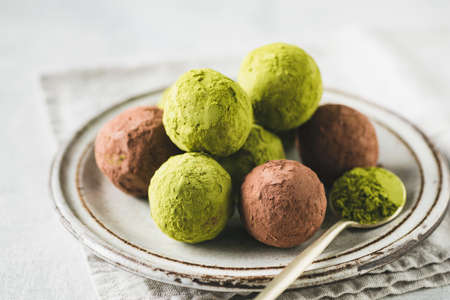 Vegan protein balls or truffles with green tea matcha powderの写真素材