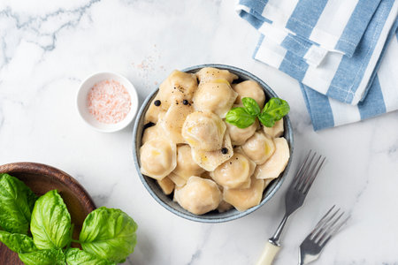 Vegetarian borscht soup in bowl served with garlic and rye bread. Top view wooden table backgroundの写真素材