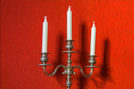 An old candlestick and its shadow on the wall. Under the sun.の写真素材